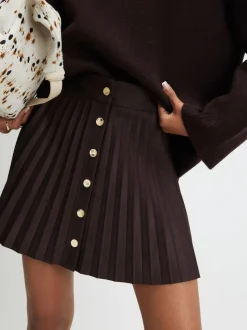 Mini-jupe plissée River Island en suédine à boutons