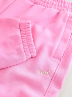 Rose vif - soi-même. Jogging à poignets